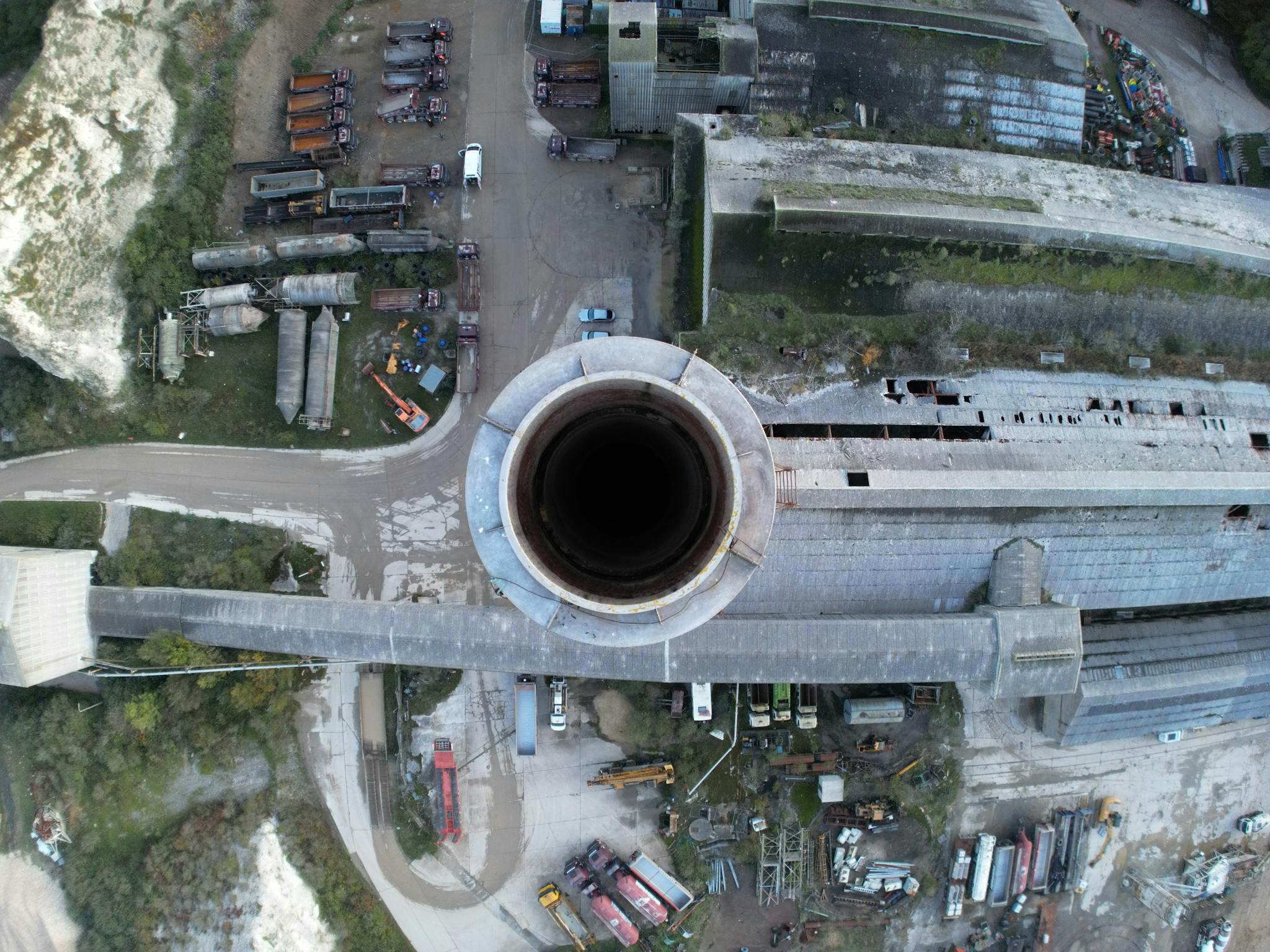 Drone shot capturing an aerial view of industrial factory and chimney, showcasing industrial infrastructure.
